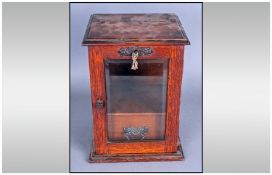 Glazed Front Single Door Oak Smokers Cabinet with a lift up lid and interior drawer. 11 inches