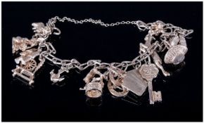 A Silver Charm Bracelet loaded with 10 plus charms, stamped 925.