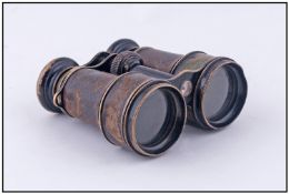 A Pair of Brass Field Binoculars with leather body. Engraved to the front 10 lenses. With unusual