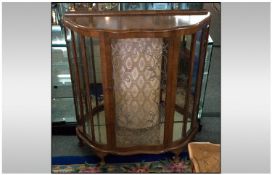 1950's Bow Front Display Cabinet, with a mirrored on cloth interior. With shaped glass shelves, on