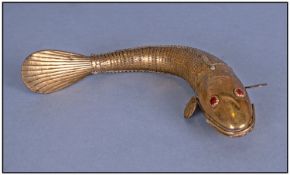 A Brass Articulated Fish with glass eyes, probably Indian. 9 inches long.