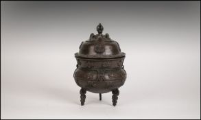 Chinese Bronze Lidded Koro With Applied Decoration. Raised on Tripod Base. 7.5" in height.