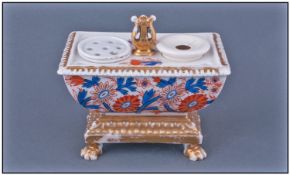 Sarcophagus Shaped Porcelain Inkstand in the Imari palette, with gilded quadruped base, surmounted