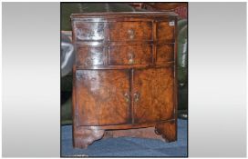 Reproduction Walnut Corner Unit standing with two drawers above a cupboard, on brancher type feet.