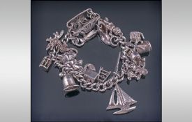 A Vintage Silver Charm Bracelet, loaded with 20 charms. 78.7 grams.