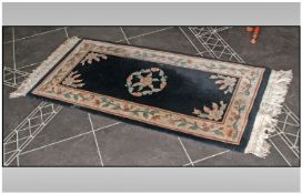 Black Chinese Wool Rug, 56 by 27 inches.
