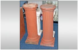 A Pair of Moulded Terracotta Coloured Columns, of reeded form with square bases. Height 35 inches.