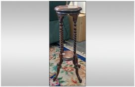 A Mahogany Candy Twist Columned Round Plant Pot Stand on shaped feet. 30 inches high.