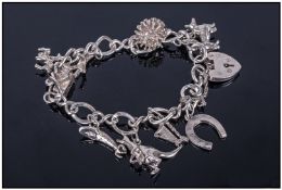 Ladies Silver Charm Bracelet. Loaded with 9 Silver Charms Of Various Designs And Subjects. Padlock