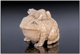 Japanese Late 19th Century Fine And Signed Ivory Netsuke, in the form of a mother toad, with baby