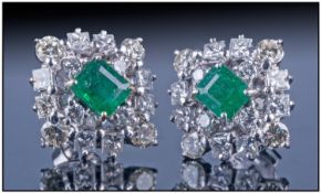 Pair of Emerald and Diamond Earrings central deep green coloured emeralds surrounded by round