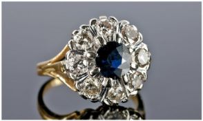 18ct Gold Set Diamond and Sapphire Ring Flower Head Design. The central sapphire surrounded by 8