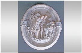 A Large French Decorated Bisque Oval Wall Plaque depicting a couple in an embrace with cupid. circ