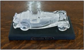 Glass Sculpture Of A Mercedes Car. Raised on a rectangular black wooden stand. Plaque to stand reads