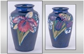 Moorcroft Small Vase. Orchids design on blue ground.