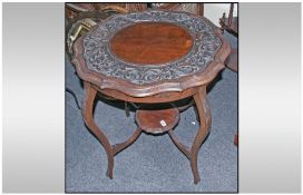 An Edwardian Carved and Shaped Top Centre Table on carved cabriole legs, supported by a shaped