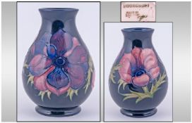 Moorcroft Vase. Clematis design on blue ground. Height 5.5 inches. Overpainting to body of vase.
