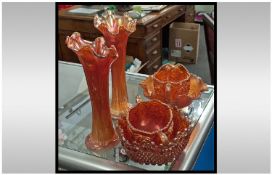 Six Pieces of Orange Carnival Glass comprising of two vases, two cream jugs and two dishes.