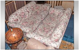 Pair Of Laura Ashley Two Seater Sofas. Classic pink floral design on cream ground. Removable seat