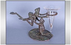 An Unusual Bronzed Metal Epern, Depicting Two Frogs Dancing and Holding a Glass Flute. Height 8".