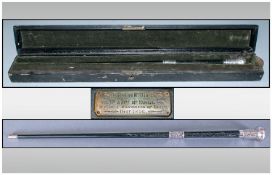 An Ebony and Silver Mounted Baton in a leather case, with an inscription plaque. 'Presented to