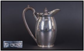 A Silver Lidded Water Jug Of Good Quality. Hallmark Sheffield 1913. Makers mark M&H Co. Stands 7.5