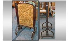 A Pugin Style Oak Fire Screen, with a sliding embroidered tapestry screen centre. Pulled from the