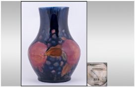 Moorcroft Signed Vase. Pomegranates and berries design. Circa 1920's. Restoration to neck area.