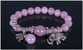 Rose Quartz Bracelet With Charms, round rose quartz beads threaded onto jeweller's elastic, with