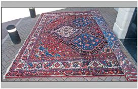 Good Bakhtiari Carpet, West Persia. The lozenge field with a lattice of polychrome medallions framed