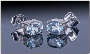 Aquamarine Oval Stud Earrings, each oval brilliant blue/green stone held with a double claw to