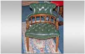 Green Leather Captains Chair, with metal studs to the back. Mahogany stained frame and square