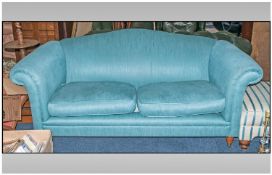 Contemporary Two Seater Sofa, with mint green cotton upholstery. Raised on four wood feet on