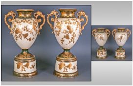 A Pair of Victorian Staffordshire Pottery Vases on pedestal bases, profusely gilded, with ornate