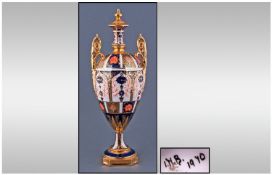 Royal Crown Derby Style Two Handled Urn Shaped Vase. Imari pattern. Stands 11.75 inches high.