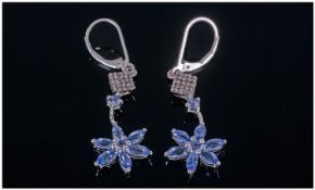 Tanzanite And Diamond Lever Back Earrings, each drop having a 6 petal flower comprising 6 marquise