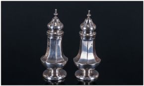 Edwardian Pair Of Silver Pepperettes Of Shaped Form. Hallmark Birmingham 1913. Each 3 inches high.