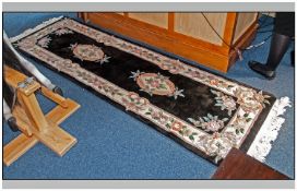 Kayam Wool Hall Runner, floral Pastel border on a black ground. 96 x 30 inches.
