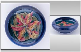 Moorcroft Small Footed Bowl. Orchids design on blue ground. Circa 1950's, Diameter 5 inches. Good