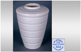 Wedgwood Keith Murray Ribbed And Tapered Vase. Cream colour way. Stands 7.5 inches high.