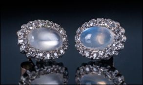 Ladies Moonstone And Diamond Pair Of Stud Earrings. The central polished moonstone surrounded by