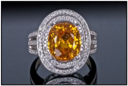 14ct White Gold Diamond Ring, Set With An Oval Cut Yellow Sapphire Surrounded By Two Rows Of