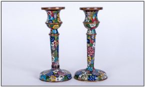 Cloisonne Pair Of Candlesticks. Circa 1920s. Each candlestick stands 6 inches high.