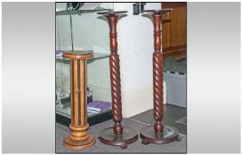 A Pair of Mahogany Finish Barley Twist Columns, 34 inches high. Together with a small beech