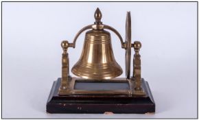 A Vintage Brass Liberty Bell, raised on a black stepped base. Working order. Height 7 inches.