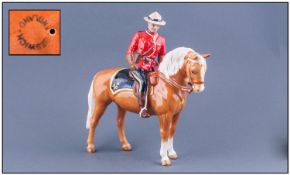 Beswick Rare Colour Way Figure. Canadian mountie, sitting on a palomino horse. Designer Arthur