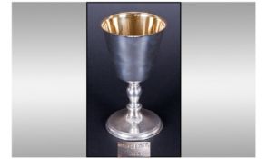 A.E Jones. A fine silver and silver gilt goblet with knopped stem and spreading foot. Hallmarked for