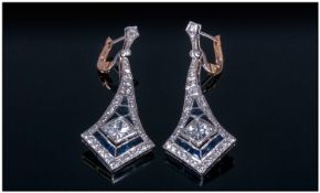 Pair of Art Deco Style Platinum Earrings set with a central princess cut diamond surrounded by