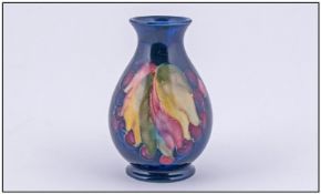 Moorcroft Small Vase. Leaves and berries design on blue ground. Height 3.75 inches.