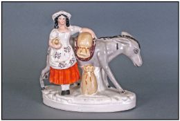 Early Staffordshire Pottery Figure, Woman With Mule, Circa 1840's. Stands 8" in height.